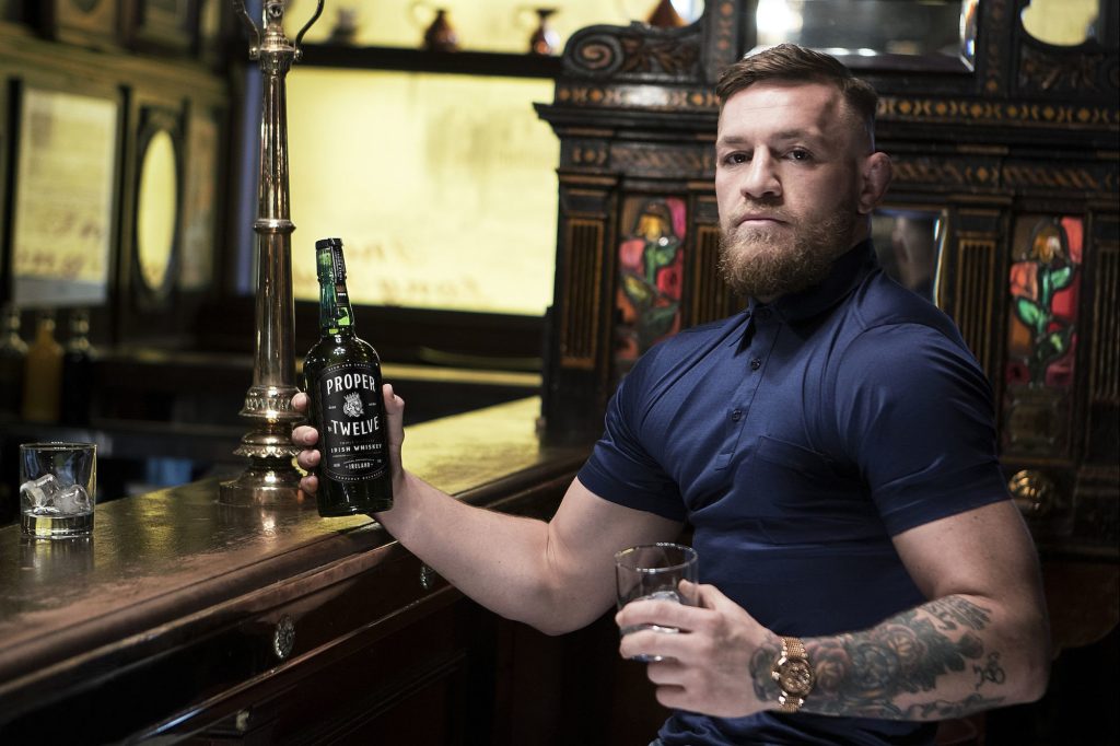 Conor McGregor in posa con una bottiglia del suo Whiskey Proper 12 - Kombatnet News